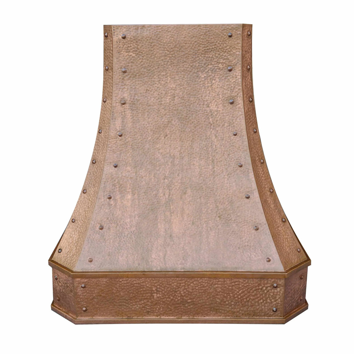 A vintage copper range hood with a classic curved shape and textured surface, featuring rivets and an apron.