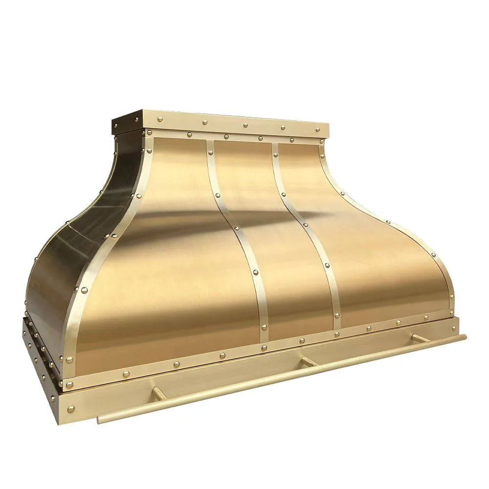 A handcrafted brushed brass range hood with round rivets and straps, showcasing its sleek design.