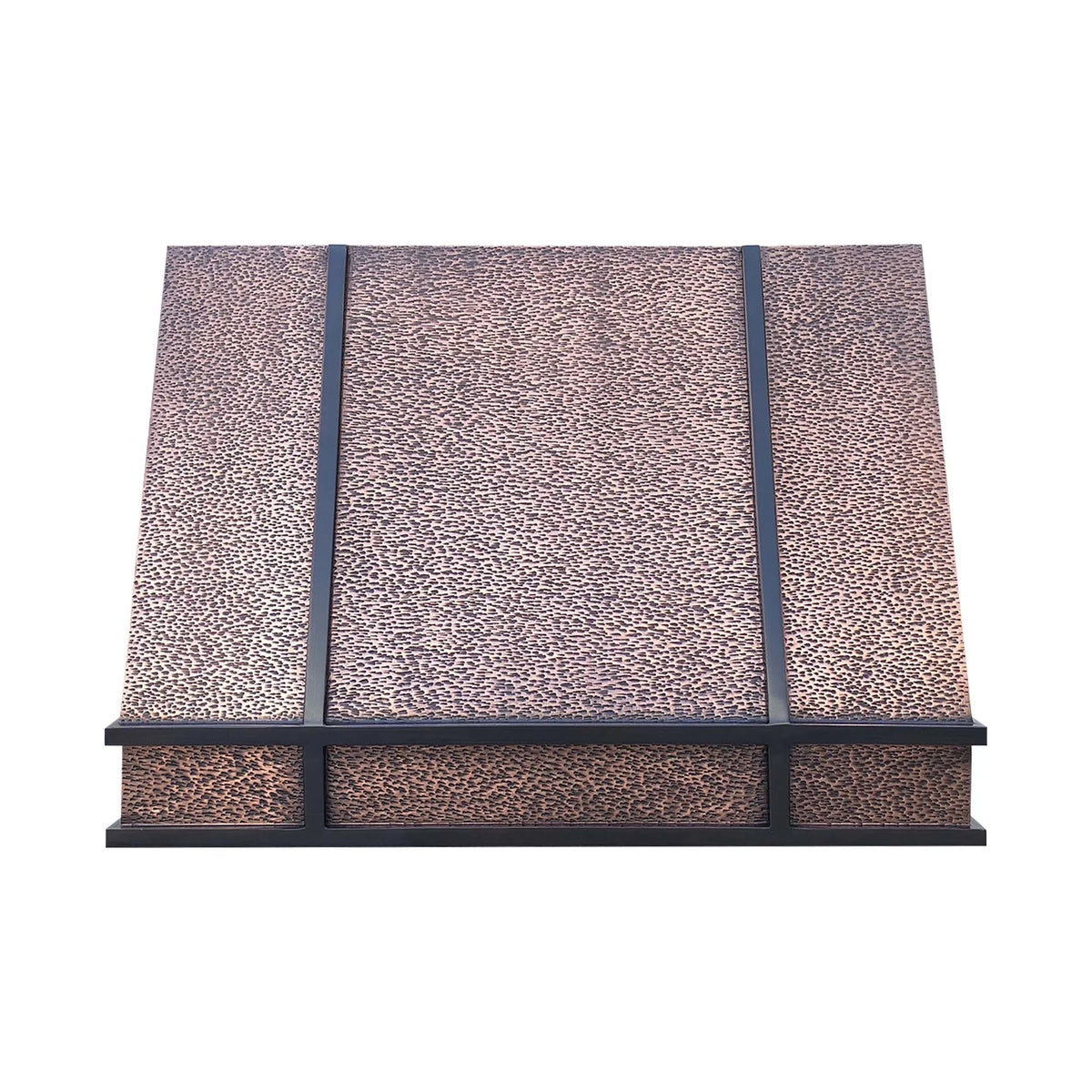 A hand-hammered copper range hood with dark antique straps