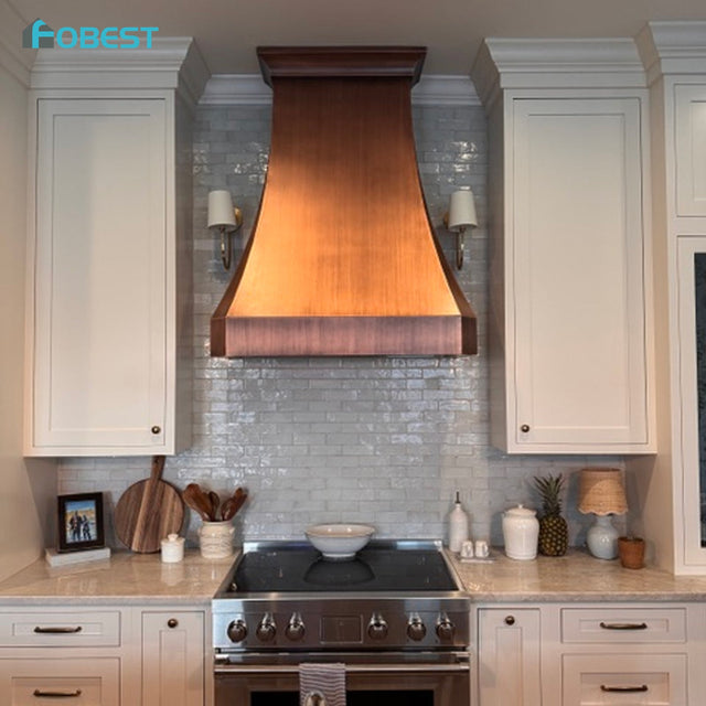 FOBEST custom copper range hood installed between white cabinets in a South Carolina homeowner’s kitchen