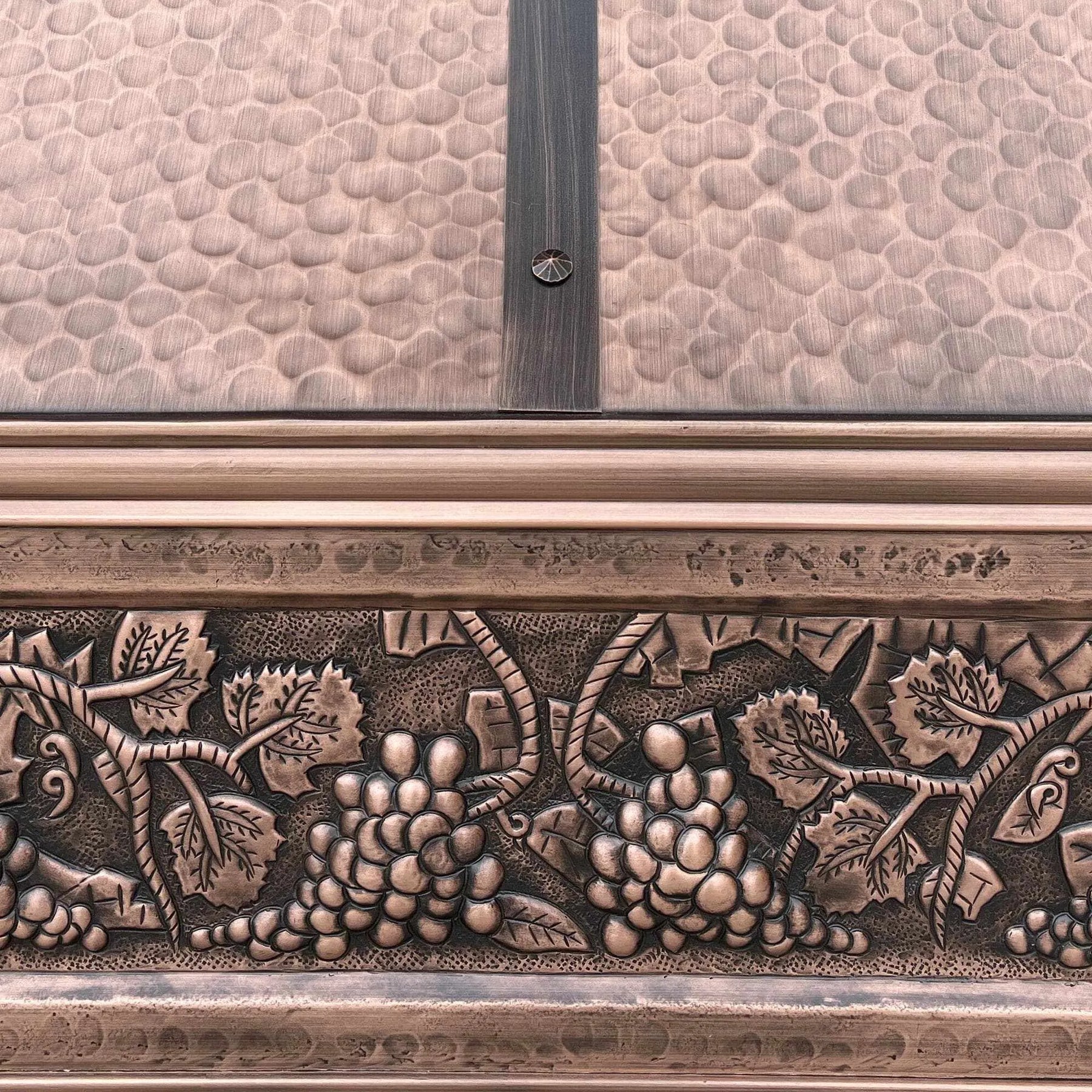 Antique copper range hood with hand curved apron design