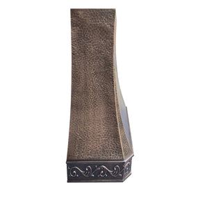 Antique copper range hood with intricate design, with vintage apron pattern.