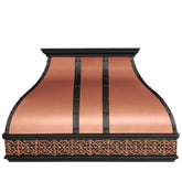 A natural copper range hood with black straps installed above a kitchen stove, featuring an antique classic pattern.