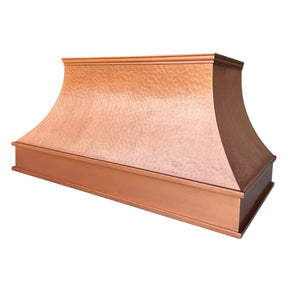 A natural copper range hood with a curved design with light hammered texture.