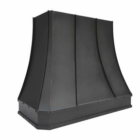 A bronze copper range hood with rivet details and hammered texture on the apron