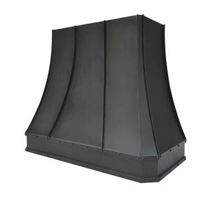 A bronze copper range hood with rivet details, handcrafted hammered texture on the apron.