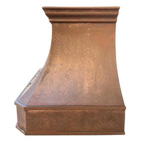 A handmade vintage copper range hood installed featuring natural oxidized texture