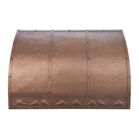 Copper stove hood with textured surface and decorative elements 