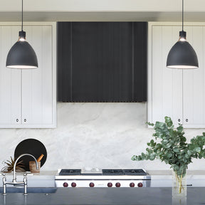 Modern kitchen with grey custom range hood, 